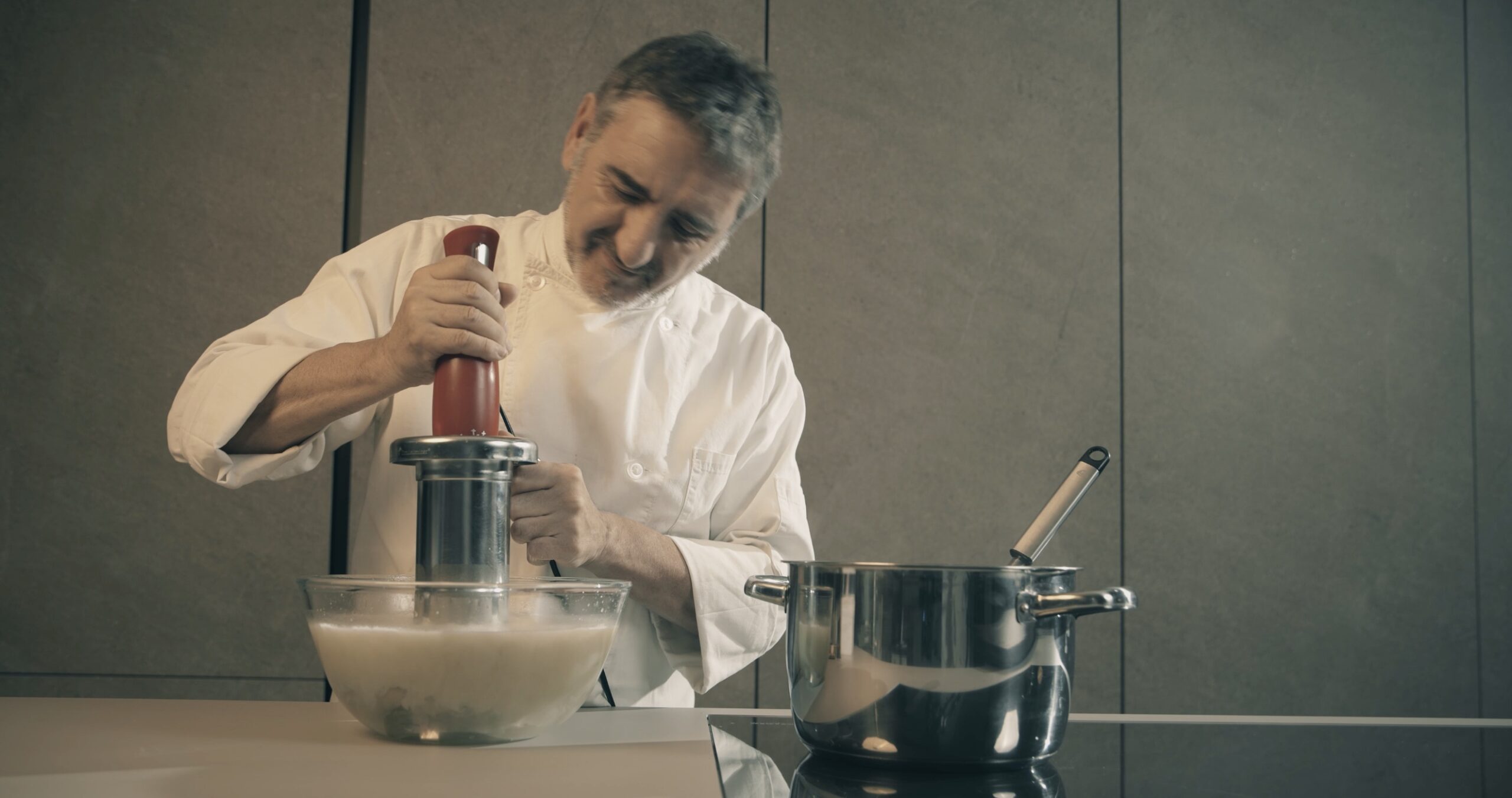 chef making soup with emulsionizer